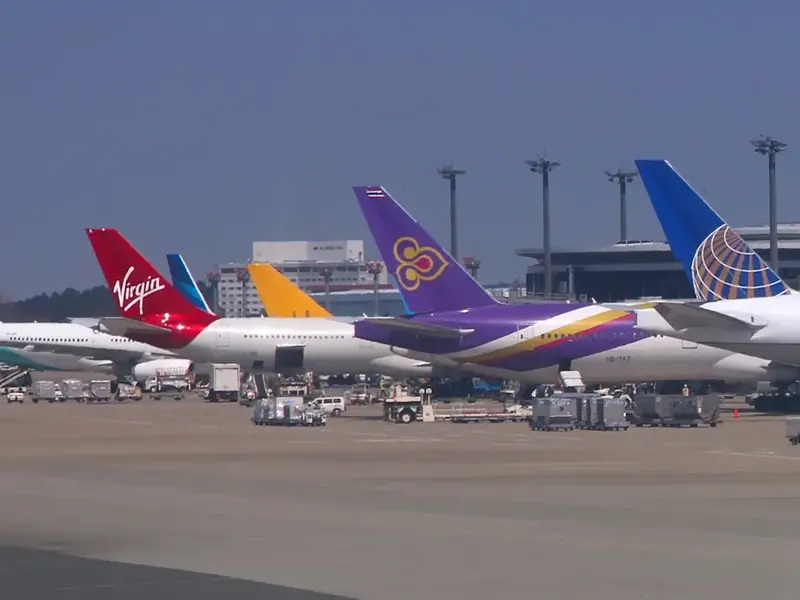 Aircraft from several airlines lined up at an airport
